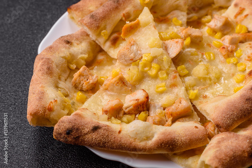 Hawaiian pizza with chicken, pineapple, corn and cheese