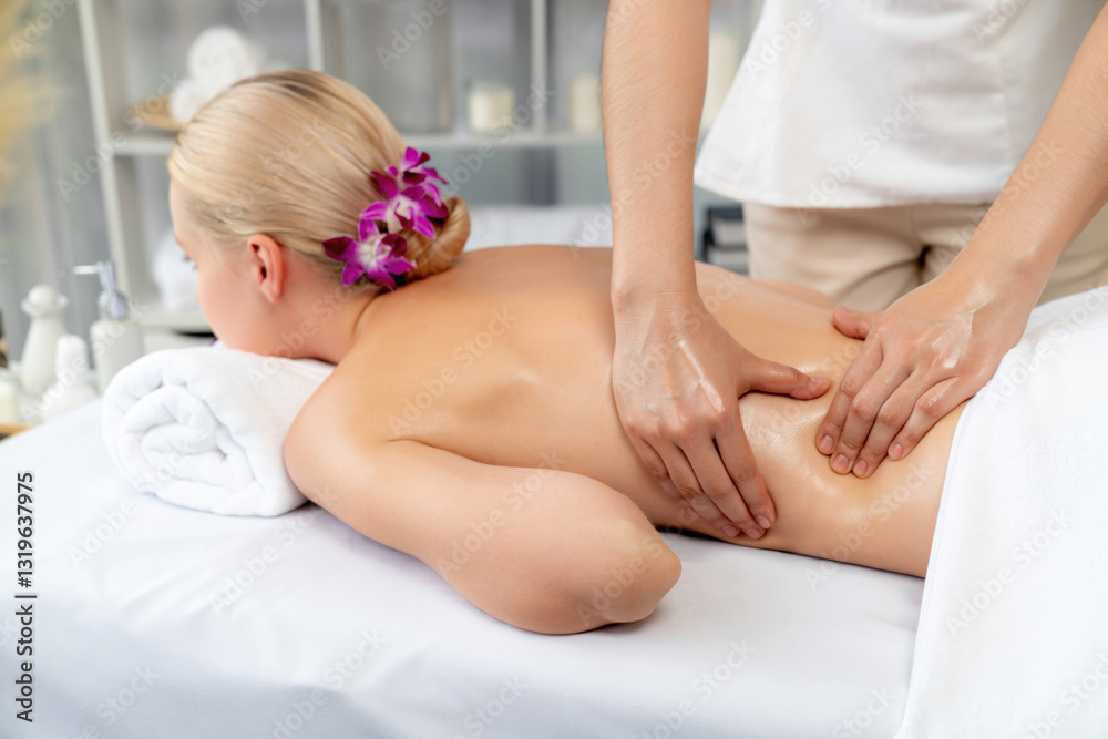 Fototapeta premium Caucasian woman customer enjoying relaxing anti-stress spa massage and pampering with beauty skin recreation leisure in day light ambient salon spa at luxury resort or hotel. Quiescent