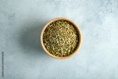 Fototapeta Naklejka Na Ścianę i Meble -  A bowl full of dried and ground natural mountain thyme on light background