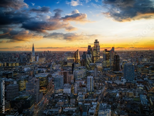 Obraz na płótnie Panoramic aerial view of the illuminated skyline at the City of London, England, during dusk w salonie