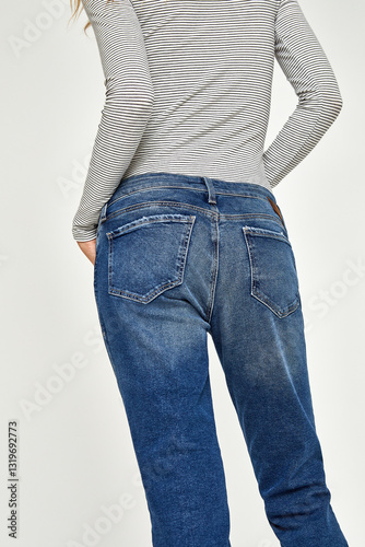 Blue casual denim for women’s with design of edges paired with black footwear and white background, Trendy short denim light blue coloured shorts paired with white heels with white background