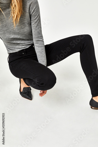 Blue casual denim for women’s with design of edges paired with black footwear and white background, Trendy short denim light blue coloured shorts paired with white heels with white background