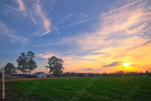 A nice sunrise over the field on a farmhouse in Lillington, North Carolina in vibrant colors