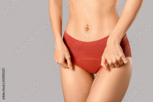 Young woman in panties on g...