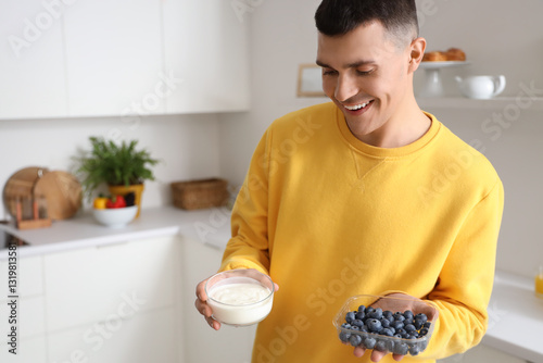 Young man with tasty yogurt...