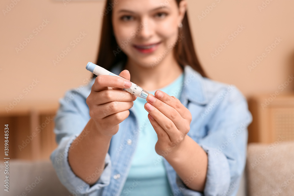 Young diabetic woman taking blood sample with lancet pen at home Young diabetic woman taking blood sample with lancet pen at home