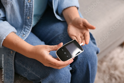 Person holding glucose mete...