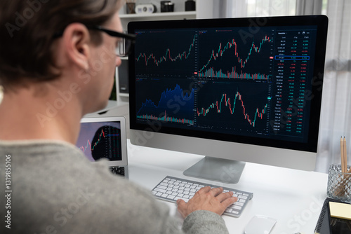Foto Business trader using computer and laptop to search highest profit value of dynamic increased stock market graph on working desk, analyzing exchange rate value on screen at modern office