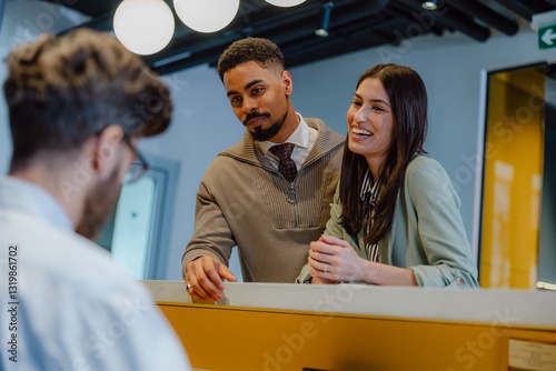 Friendly Worker Helping Clients at a Modern Office Reception Desk