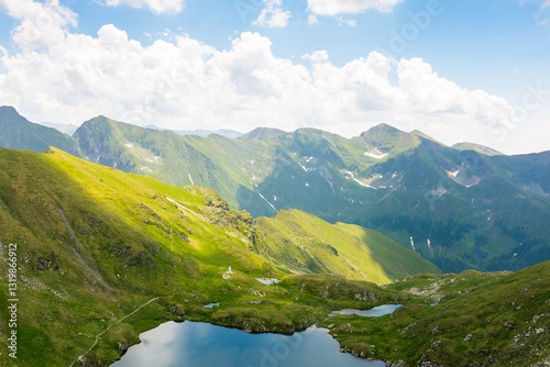 Obraz na płótnie mountain landscape of romania in summer. carpathian range. beautiful outdoor scenery with alpine lake. scenic view in to the valley. travel background with blue sky and clouds. natural environment w salonie