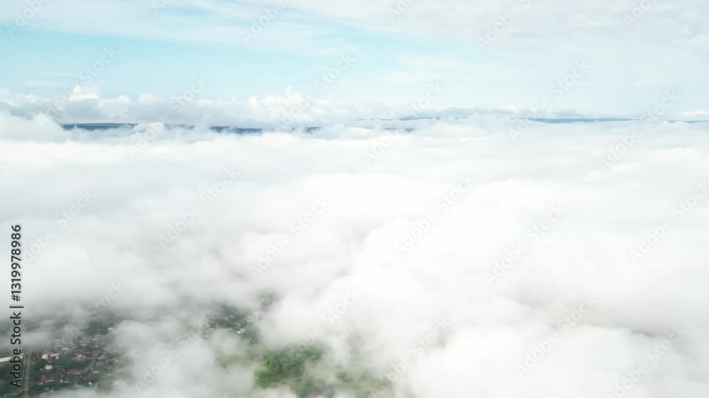 Aerial view of a landscape covered by clouds during the day Aerial view of a landscape covered by clouds during the day