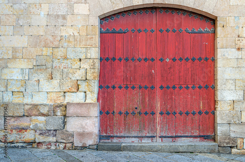 Architectural detail of an old red wooden door