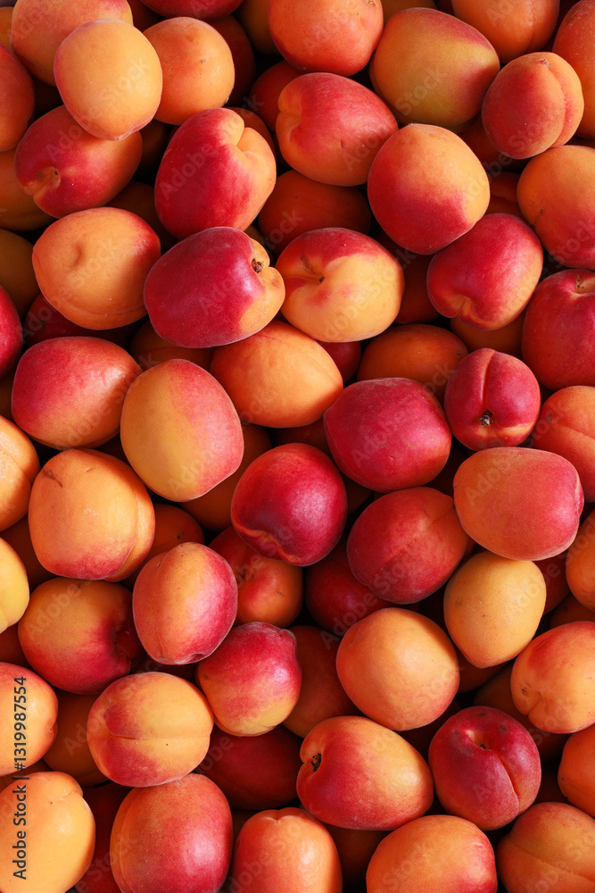 A pile of ripe nectarines, showcasing their smooth skin and rich, red-orange color up close A pile of ripe nectarines, showcasing their smooth skin and rich, red-orange color up close