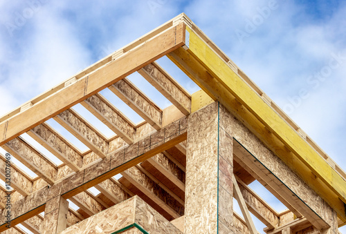 Roof corner construction detail showing engineered wood joists and Laminated Veneer Lumber (LVL) headers  with oriented strand board, Chip board wall sheathing
