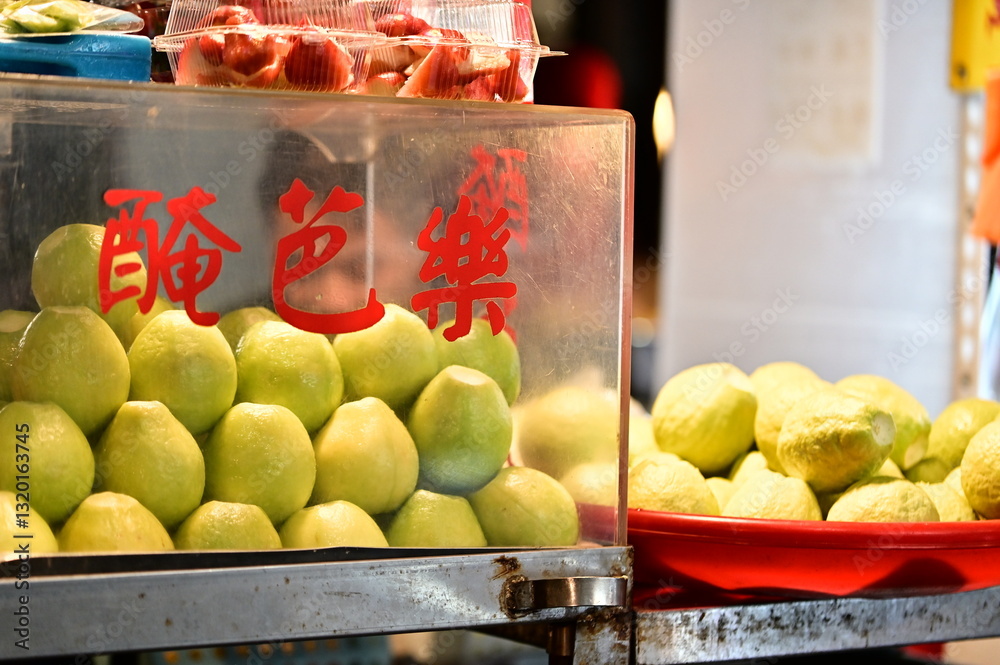 A Taiwanese night market stall showcases heaps of freshly pickled guava(醃芭樂), With a perfect balance of sweetness and tartness, this beloved snack draws in curious customers.