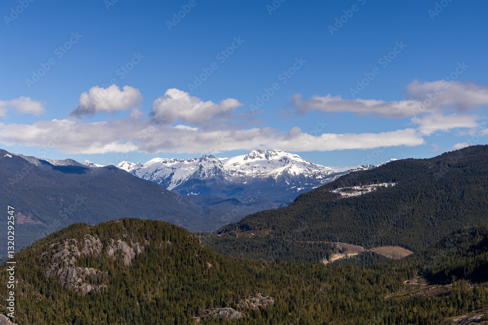Fototapeta premium Snow-Capped Chief Mountain Under Blue Sky in Scenic Squamish, BC Landscape