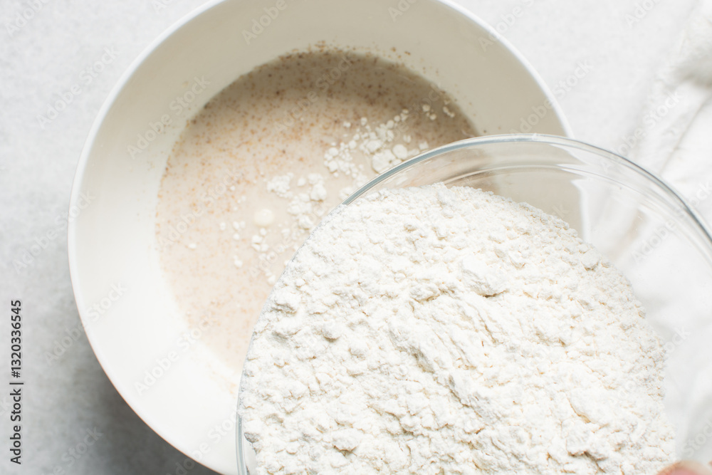 overhead view of All purpose flour in a bowl, top view of baking flour in a glass bowl overhead view of All purpose flour in a bowl, top view of baking flour in a glass bowl
