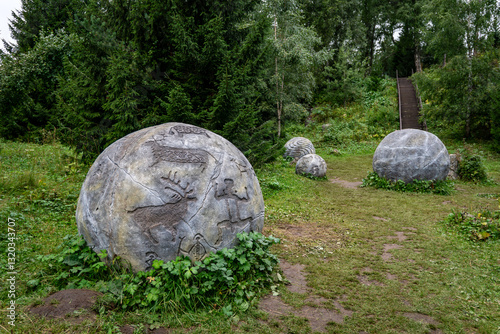 Stone balls depicting ancient petroglyphs. landmark of Altai. The place of power is in the Altai Mountains in the forest on Malaya Sinyukha mountain. photo