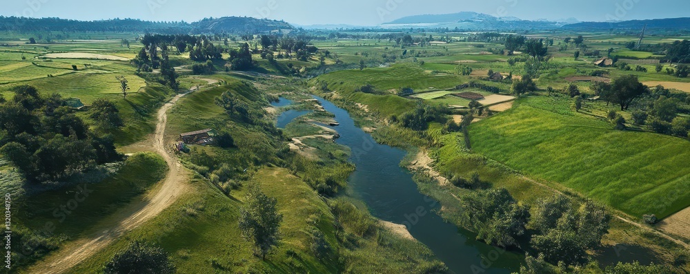 Serene Aerial View of Lush Green Fields and Calm River Landscape Serene Aerial View of Lush Green Fields and Calm River Landscape