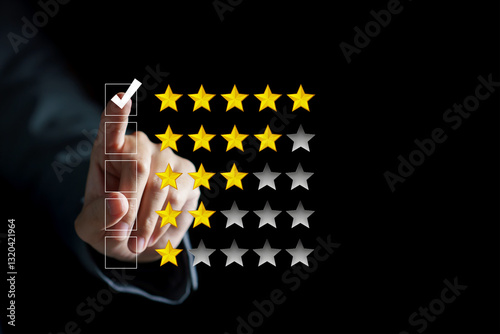Hand touching and doing mark to five yellow stars on black background, the best customer satisfaction and evaluation for good quality product and service.