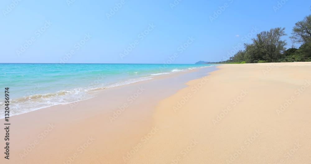 Sunny beach landscape with calm ocean waves and clear blue sky, expansive and serene. High clarity, suitable for wellness retreats or mindfulness content.