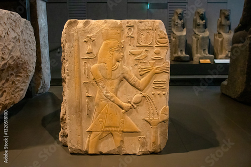 ancient Egyptian carvings and hieroglyphs on sand stones at the Grand Egyptian Museum in Cairo, Egypt