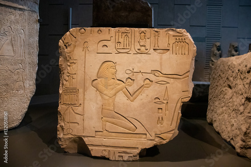 ancient Egyptian carvings and hieroglyphs on sand stones at the Grand Egyptian Museum in Cairo, Egypt
