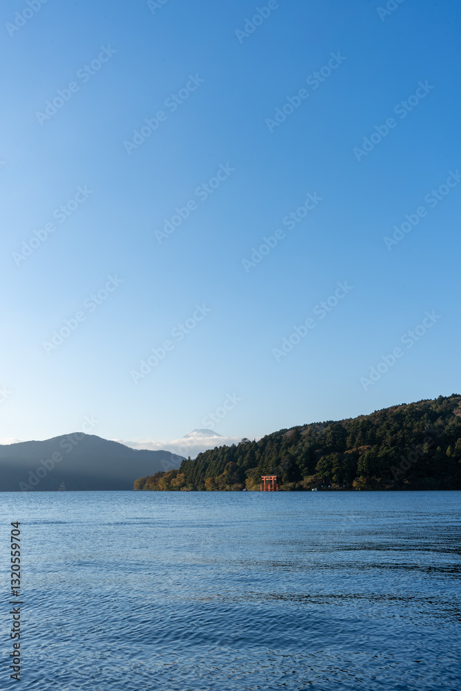 Fototapeta premium Mt. Fuji and red Torii gate on lake Ashi at Sunset, Hakone, Japan