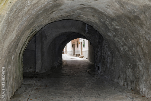 Cobblestone street going through a dark tunnel in Radovljica, Slovenia