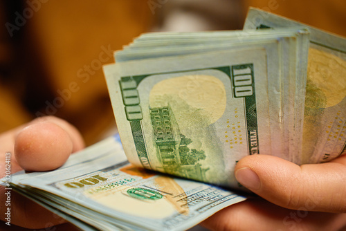 Obraz na płótnie Man counting US dollar banknotes, close up. Cash savings and financial wealth concept w salonie