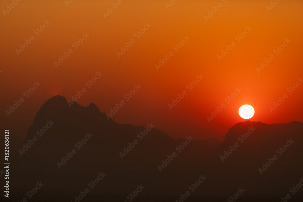 Fototapeta premium Sunrise time over the mountain with warm color tone for nature background.. at Phu Kradueng