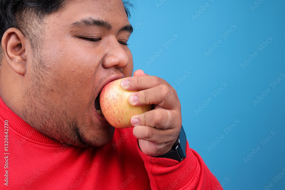 Young Asian Fat Man Holding Apple And Showing Thumb Up With Happy Expression Young Asian Fat Man Holding Apple And Showing Thumb Up With Happy Expression
