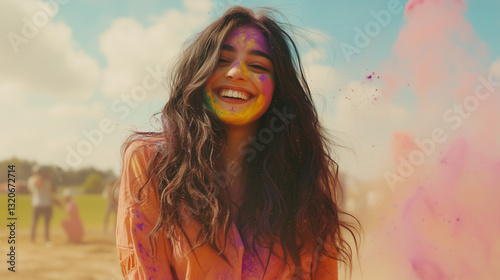 Joyful Young Indian Woman Celebrating Holi Festival with Vibrant Color Powder Explosion photo