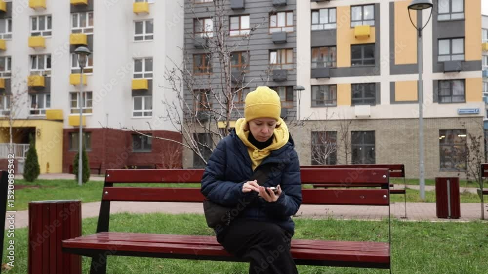 Woman using smartphone outdoors in city, using a smartphone application, walking in an urban lifestyle, holding a mobile phone. Woman using smartphone outdoors in city, using a smartphone application, walking in an urban lifestyle, holding a mobile phone.