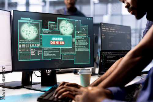 Computer scientist in server farm fighting hacker managing to pass firewall and stealing data. Employee receiving access denied notification on PC display in data center facility