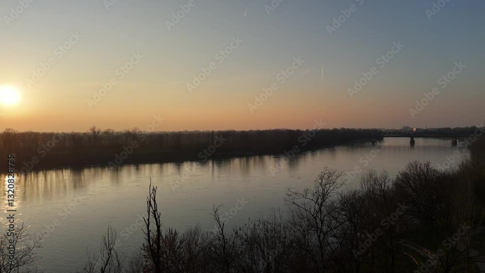 Winter sunset over the Po River in municipal park near the river, Cremona, Lombardy, Italy Winter sunset over the Po River in municipal park near the river, Cremona, Lombardy, Italy