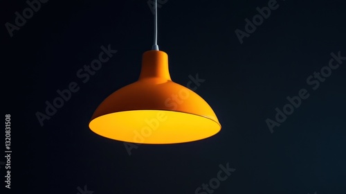 Bright orange pendant light against dark background