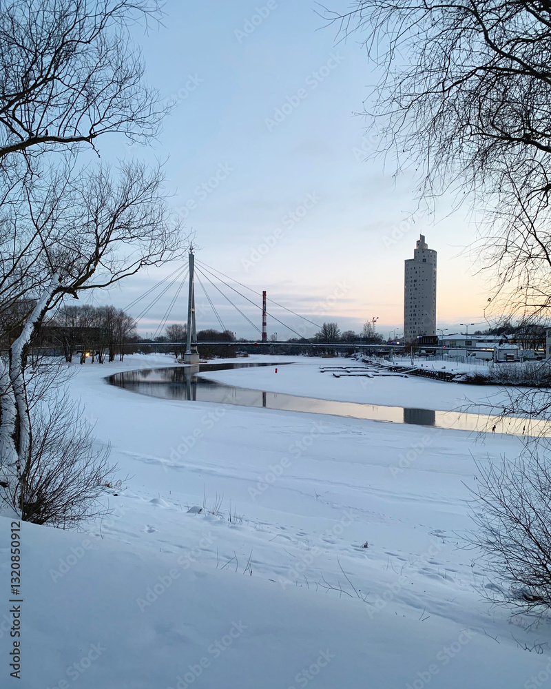Winter cityscape with frozen Emajõgi river, Turusild bridge and Tigutorn building in Tartu, Tartumaa, Estonia, February 2021