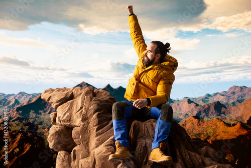 Satisfied adventure seeker stands at the top a towering mountain, taking in the epic view and feeling proud of his hiking achievement. Strong joyful trekker feels the rewarding experience.