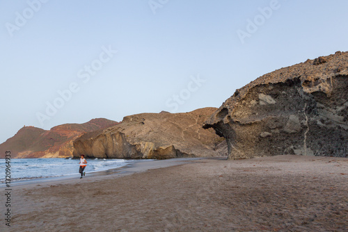 Young man running on monsul beach at dawn in the cabo de gata natural park