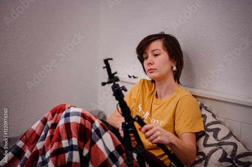 Wallpaper Mural Woman Assembling Tripod While Sitting in Bed Torontodigital.ca