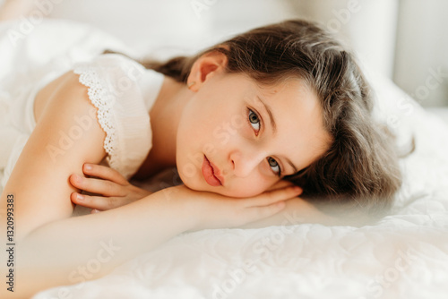Studio portrait of a delicate 10-year-old girl in a festive Christmas setting