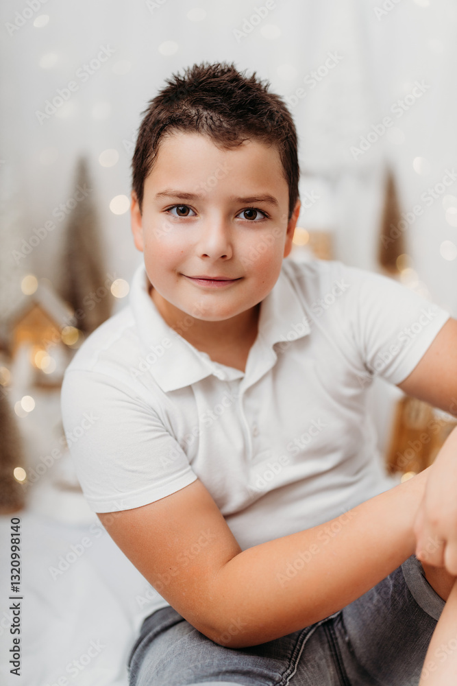 Studio portrait of a 10-year-old boy in a festive Christmas setting. Studio portrait of a 10-year-old boy in a festive Christmas setting.