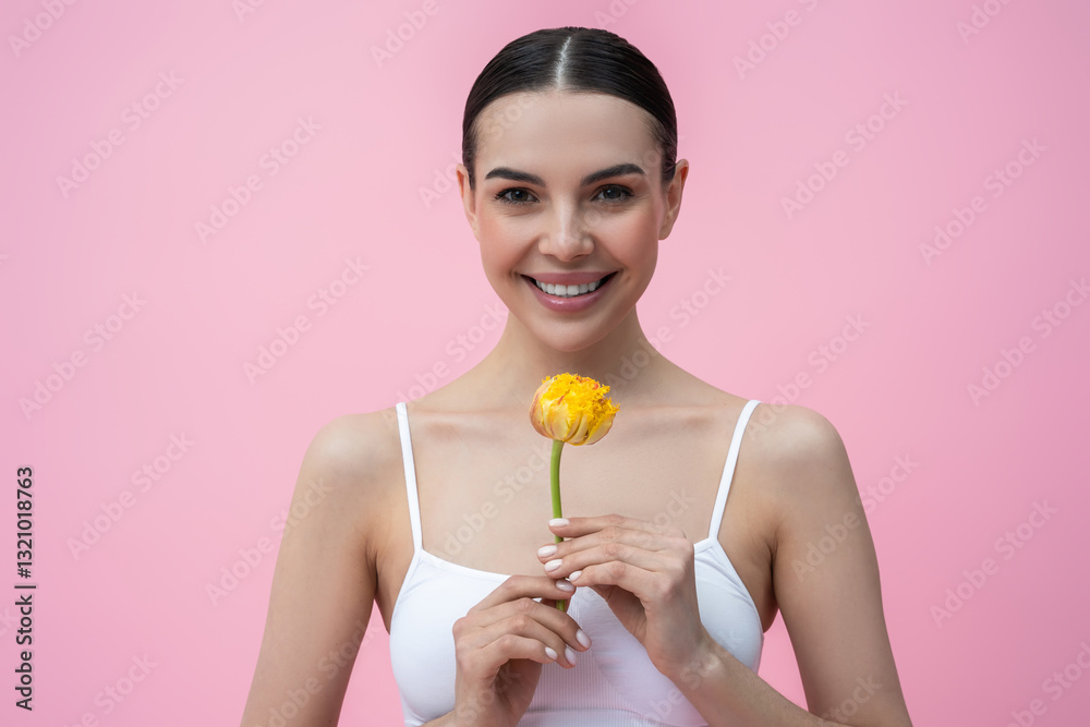 Pretty dark-haired young woman in white lingerie with a flower in hand Pretty dark-haired young woman in white lingerie with a flower in hand