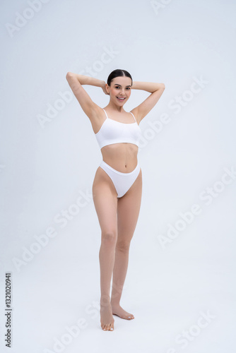 Pretty long-haired young caucasian woman in white underwear