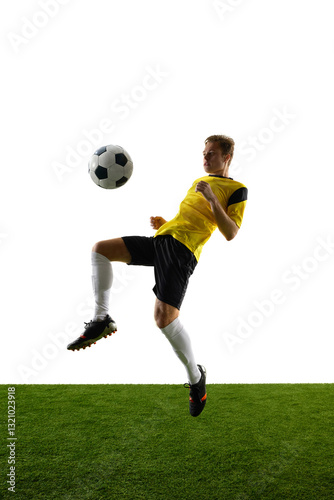 Wallpaper Mural Dynamic image of man, soccer player in yellow jersey and black shorts, kicking ball with knee, training against white background. Concept of sport, action, competition, game, active lifestyle. Ads Torontodigital.ca