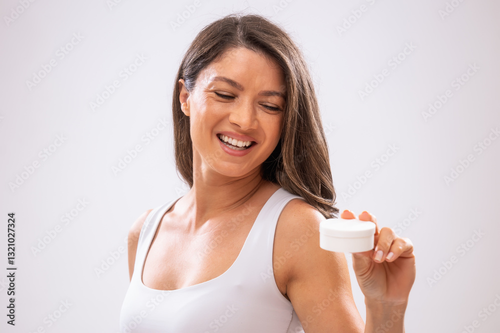 Portrait of adult woman who is holding skin cream. Portrait of adult woman who is holding skin cream.
