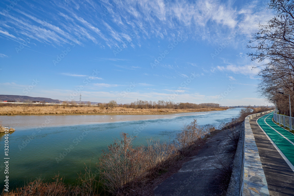 landscape with a bike path on the bank of a river landscape with a bike path on the bank of a river