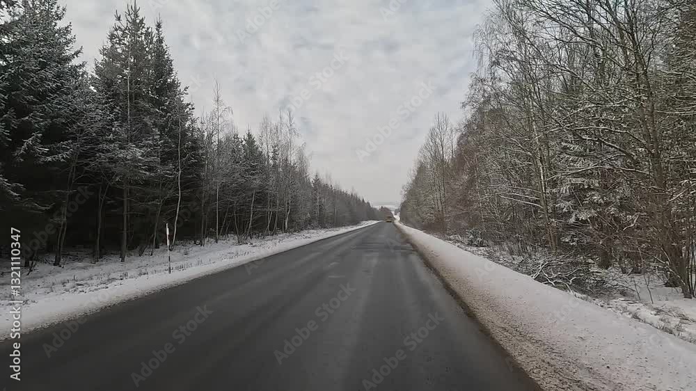 Winter road with snow, highway with cars on a sunny winter day. Winter landscape, road and shoulder covered with snow. Winter road with snow, highway with cars on a sunny winter day. Winter landscape, road and shoulder covered with snow.