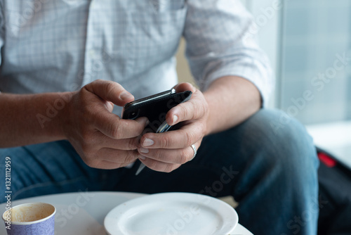 man using phone at airport photo